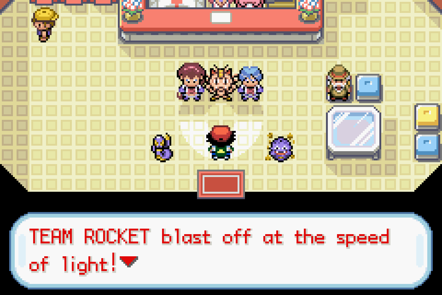 Jessie, James and Meowth inside a Pokémon Center delivering their motto, with the dialogue box open at the bottom of the screen.
